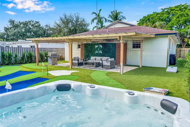 a view of a house with a yard and sitting area