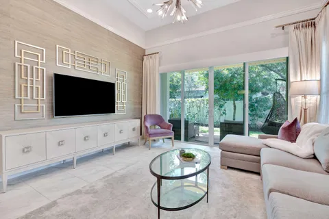 a living room with couch and a floor to ceiling window