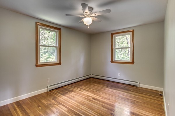 6 Hanson Road Wilmington, MA 01887 - Photo 23 of 29 a view of an empty room with window and wooden floor