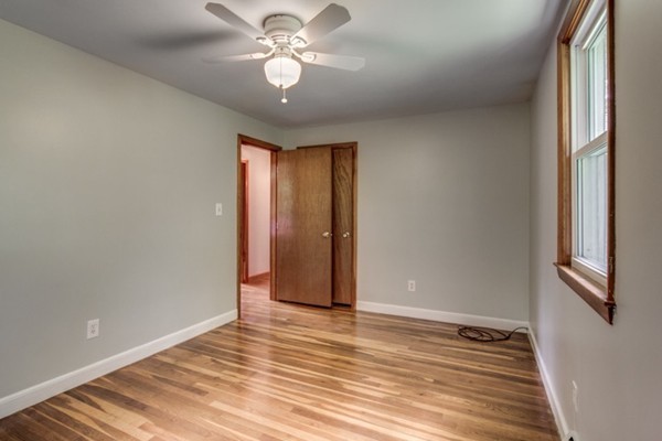 6 Hanson Road Wilmington, MA 01887 - Photo 24 of 29 a view of an empty room with wooden floor and a window