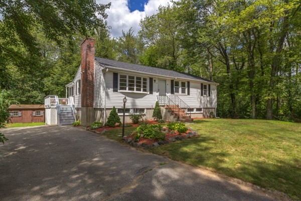 6 Hanson Road Wilmington, MA 01887 - Photo 26 of 29 a front view of a house with a yard and potted plants