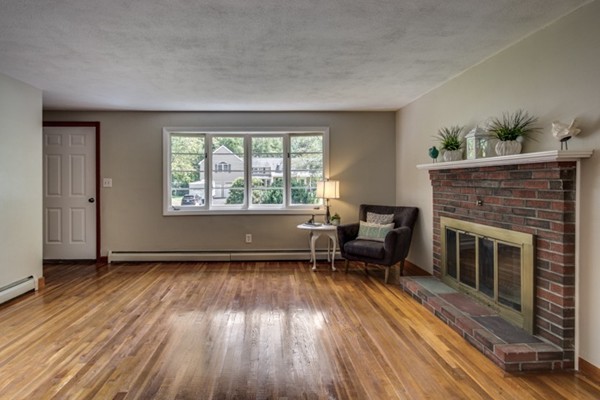 6 Hanson Road Wilmington, MA 01887 - Photo 4 of 29 wooden floor fireplace and windows in an empty room