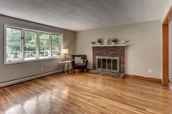 6 Hanson Road Wilmington, MA 01887 - Photo 5 of 29 a living room with furniture and a fireplace