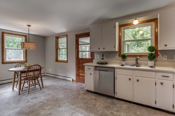 6 Hanson Road Wilmington, MA 01887 - Photo 9 of 29 a kitchen with sink cabinets and window