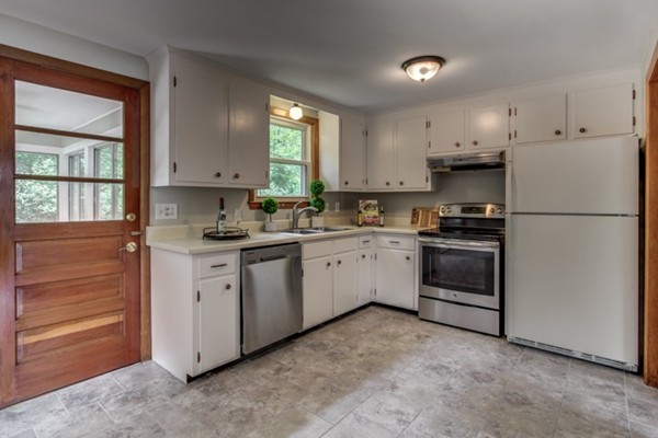 6 Hanson Road Wilmington, MA 01887 - Photo 10 of 29 a kitchen with white cabinets and white appliances