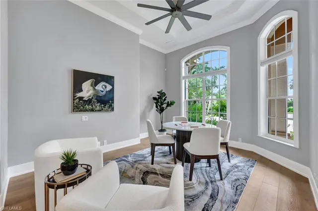 a dining room with furniture a window and wooden floor