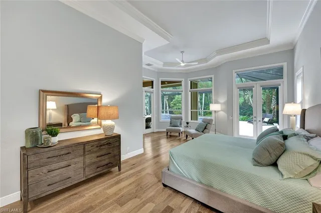 a bedroom with a large bed and windows