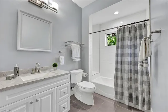 a bathroom with a shower sink vanity mirror and toilet