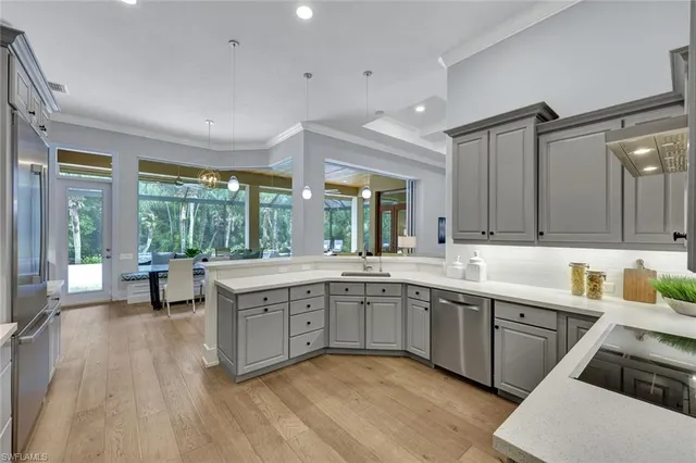 a large kitchen with a lot of counter space and a sink