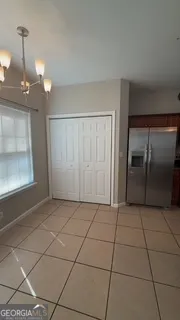 a view of a livingroom with an empty space and a window