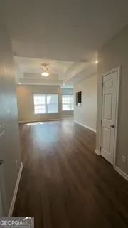 a view of empty room with wooden floor