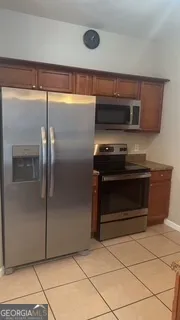 a kitchen with a stove and a refrigerator