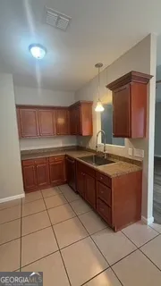 a kitchen with stainless steel appliances granite countertop a sink and cabinets