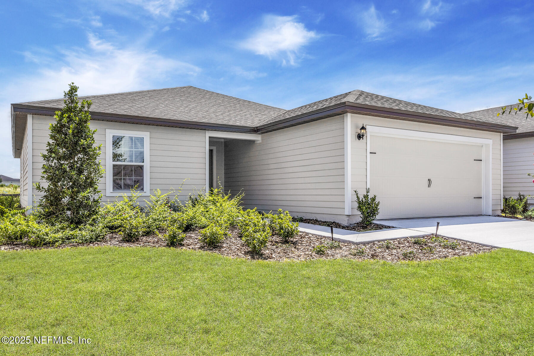 37151 Whippoorwill Court Hilliard, FL 32046 - Photo 2 of 19 a front view of house with yard and trees around