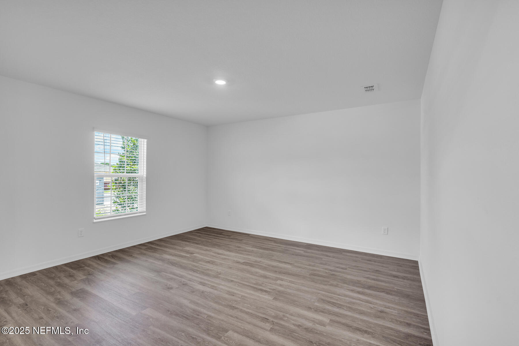 37151 Whippoorwill Court Hilliard, FL 32046 - Photo 8 of 19 a view of an empty room with wooden floor and a window