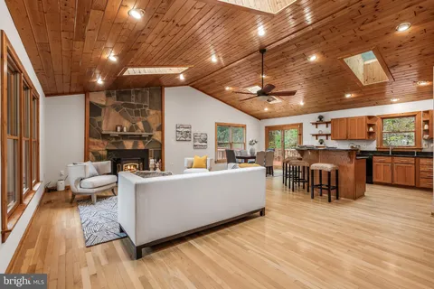 a kitchen with stainless steel appliances granite countertop a refrigerator a stove a sink and a microwave