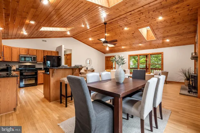 a living room with fireplace furniture and a floor to ceiling window