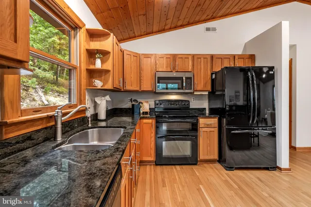 a spacious bedroom with a large bed and a chandelier fan