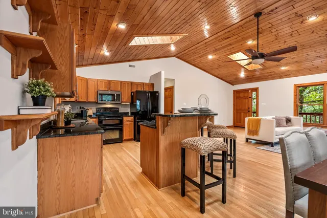 a bedroom with a large bed and a chandelier fan