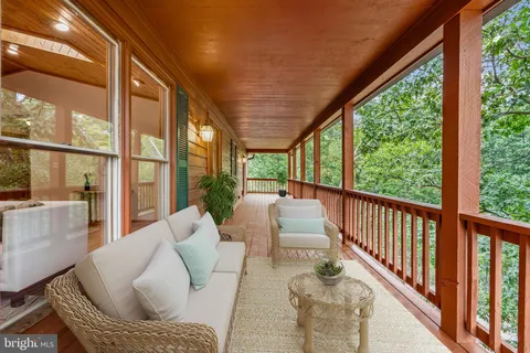 a kitchen with stainless steel appliances granite countertop wooden cabinets a sink and a wooden floor