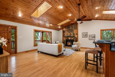 a bathroom with a granite countertop toilet a sink and a mirror