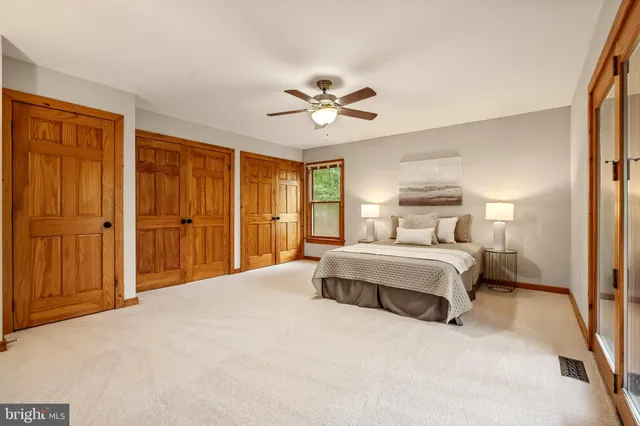 an empty room with windows and closet