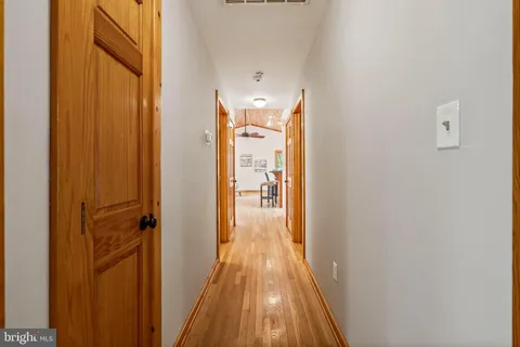 a view of backyard with a deck and wooden floor