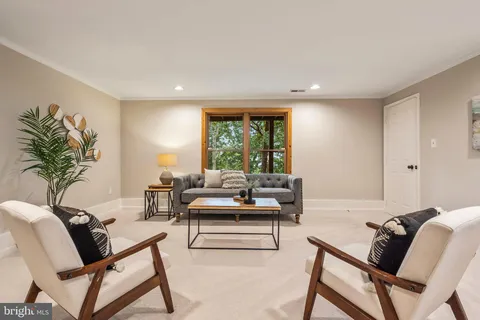 an aerial view of a house with a yard and outdoor seating