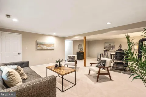 an aerial view of residential house with outdoor space and trees all around