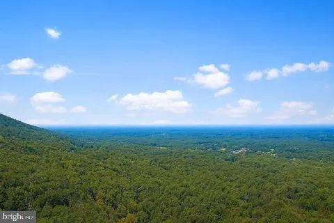 a kitchen with stainless steel appliances granite countertop table chairs sink and cabinets
