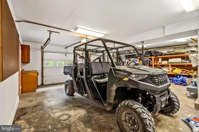 a kitchen with stainless steel appliances kitchen island granite countertop wooden floors and a view of living room