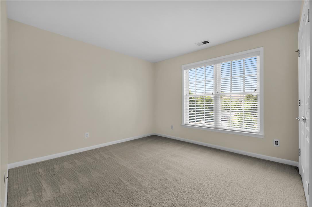 1709 Travers Road Breinigsville, PA 18031 - Photo 41 of 55 A well-lit bedroom offering a neutral palette, plush carpet, and ample natural light from a broad window.