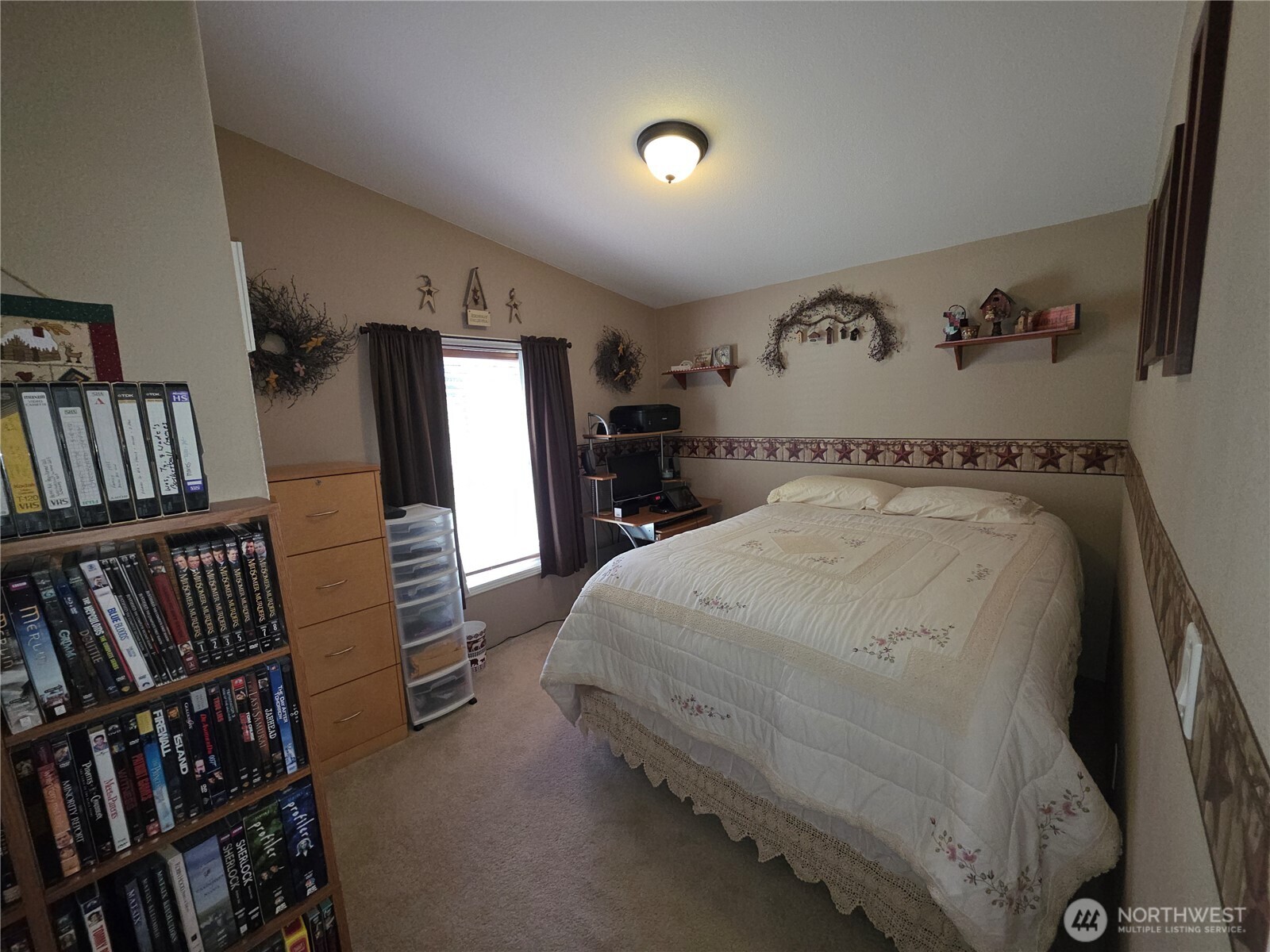 393 Summer Road Tonasket, WA 98855 - Photo 6 of 37 a bedroom with a bed and a book shelf