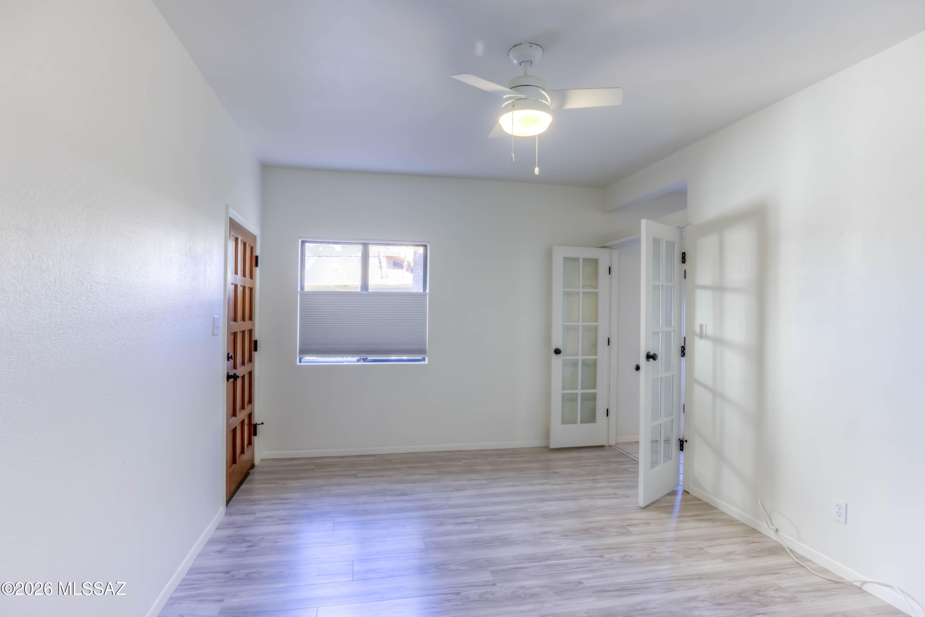 5500 North Valley View Road, Unit 123 Tucson, AZ 85718 - Photo 23 of 36 a view of an empty room with wooden floor and a window