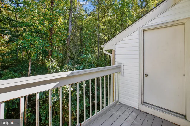 a view of a balcony with wooden floor
