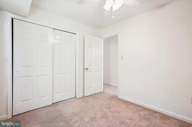 an empty room with a ceiling fan