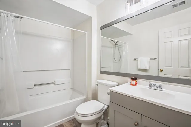 a bathroom with a sink toilet vanity and shower