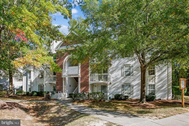 a front view of a building with trees