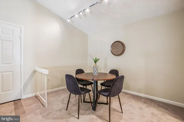 a dining room with furniture and floor to ceiling window