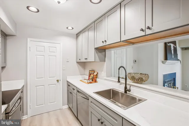 a kitchen with granite countertop a sink and cabinets