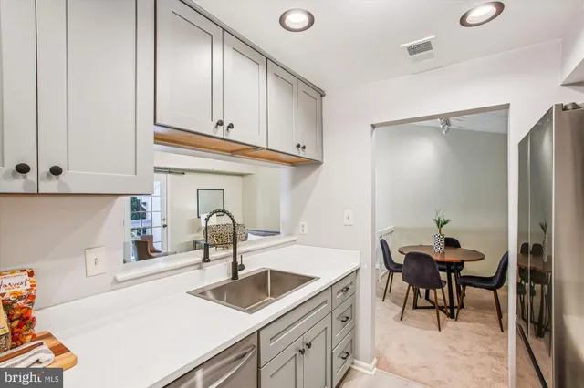 a kitchen with a sink cabinets and appliances