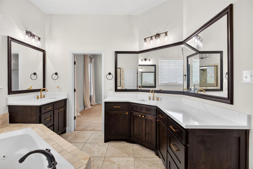 7320 Spring Ranch Court Godley, TX 76044 - Photo 24 of 38 a spacious bathroom with a sink vanity and mirror
