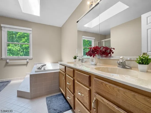 a bathroom with a tub sink and mirror