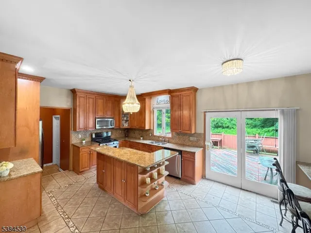 a kitchen with a stove a sink and a refrigerator