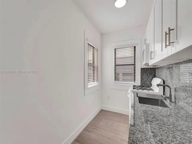 a kitchen with a sink and cabinets
