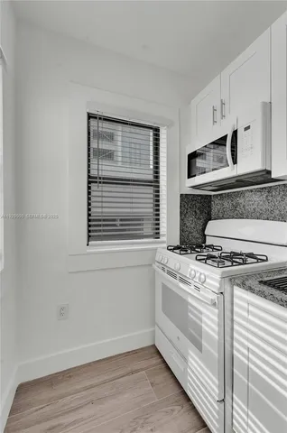 a kitchen with a refrigerator sink and stove
