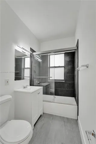 a bathroom with a sink toilet and a mirror