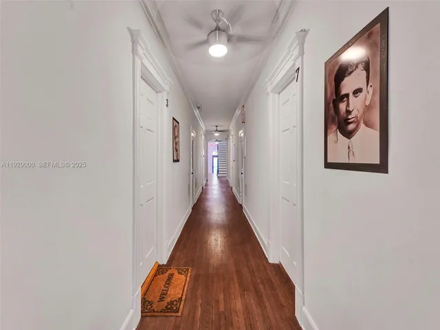 a view of a hallway with wooden floor and entryway