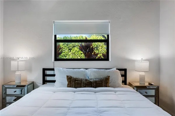 a bedroom with a bed and a lamp on table