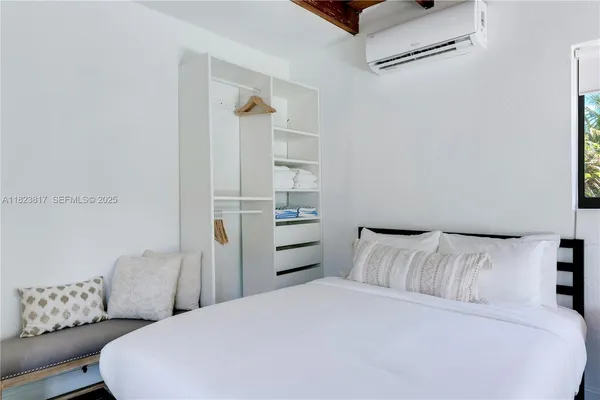 a bedroom with a bed and a couch